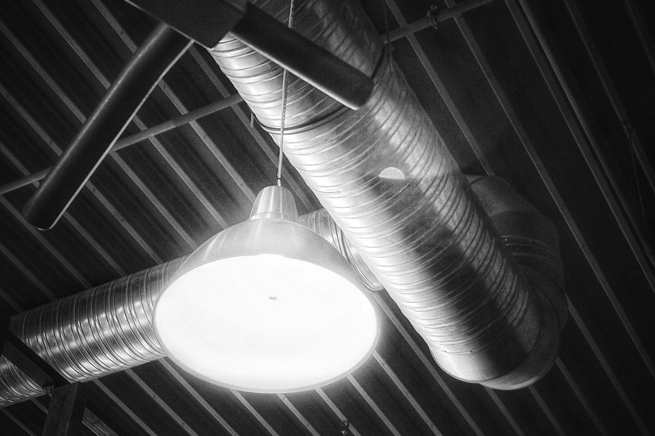 Spiral ductwork and plant lighting across an industrial ceiling.